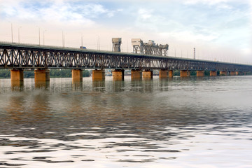 Fototapeta na wymiar Bridge across Dnepr - big Ukrainian river.
