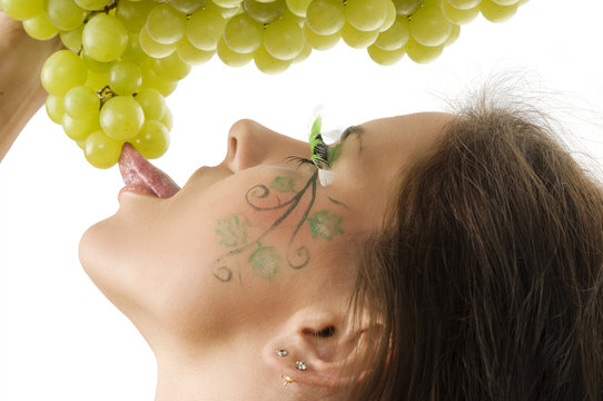 sexy brunette with a nice draw on her face licking grape