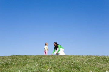 Fototapeta premium active family on green meadow