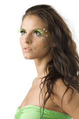 pretty girl with artificial green eyelashes and leaf painted