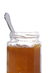 Peach jar opened with a spoon, isolated on white background