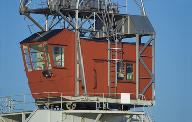 Wooden steering house of red, old style harbour crane