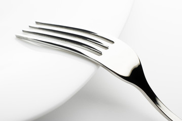 silver fork on white plate macro shoot