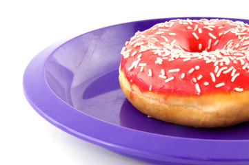 pink doughnut on a purple plate