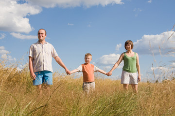 happy family walking together on a sunny day