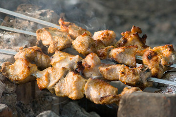 Preparing hot shish kebab on skewers