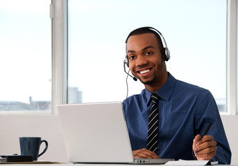 Customer Service agent in an office with laptop