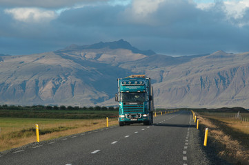 A truck on road from mountains