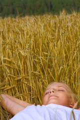 Young teenager girl sleep on wheat's field