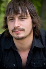 Portrait of young man on forest background