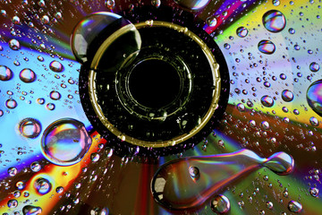 media disk with psychedelic colours and water droplets