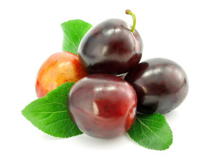 plum fruits with green leafs isolated on white background