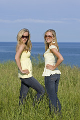 sisters wearing yellow top and jeans in the summer