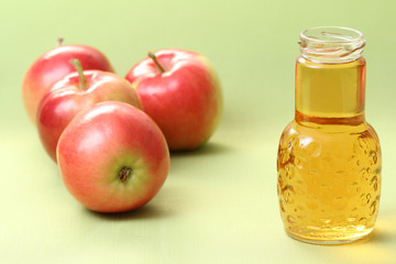 bottle of apple juice and some fresh apples