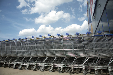 A lot of blue trolleys standing together