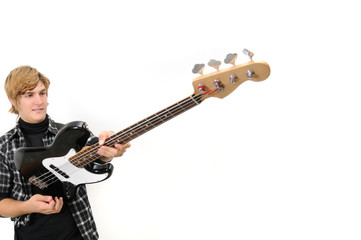 Portrait of young trendy man holding electric bass guitar