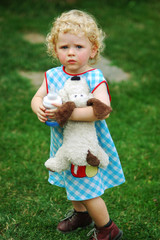 A little girl with toy in garden
