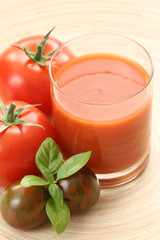 glass of fresh tomato juice and some fresh tomatoes