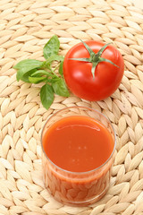 glass of fresh tomato juice and some fresh tomatoes