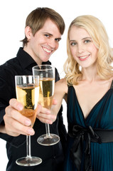 An attractive young couple drinking champagne together