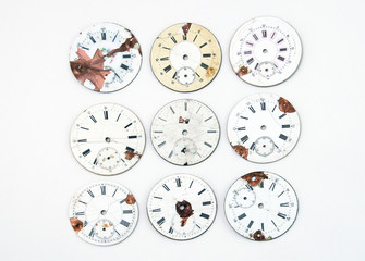 Collection of antique watch faces isolated on white.