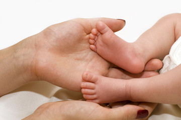 Mother's hand and baby's foot