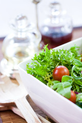 Green salad with tomatoes, olive oil and vinegar