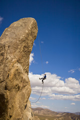 Rock climber rappelling.