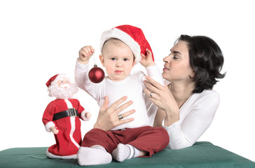 Christmas photo. Baby and mother in Santa Claus's hat