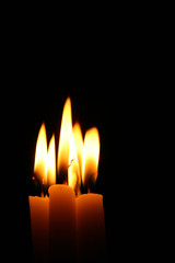 sacred candles in dark on black background