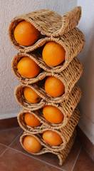 Oranges in stand for the wine bottle in the corner.