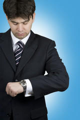 Handsome businessman looking at the watch