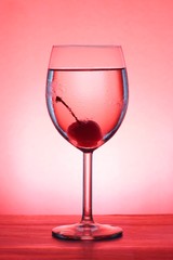 Red Cherry in a goblet over red background