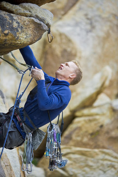 Rock climber dangling from a cliff.