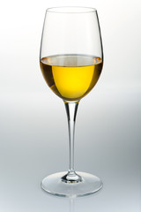 Glass of white wine over a light background