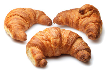 Three fresh croissants isolated over white background