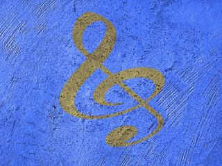 golden music note on a grunge blue wall