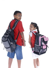 An african american brother and sister ready for school.