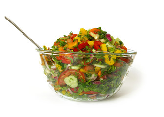 Freshness vegetarian salad in a bowl and fork isolated