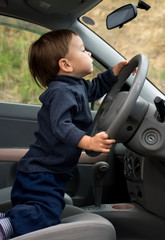 cute little boy driving a car