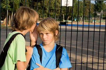 children whispering secrets, chatting , gossiping or threatening