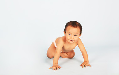 Cute baby crawling isolated shot over blue background