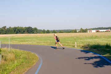 young female rollerskating on paved road