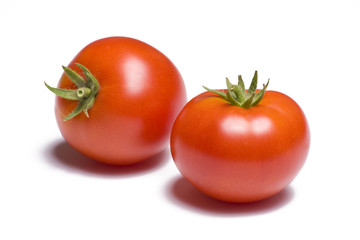 Two vibrant tomatoes on white background