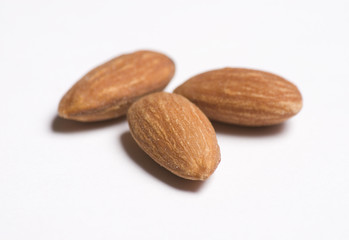 Almonds close up on white background with selective focus
