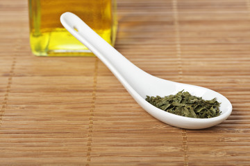 Parsley and oil with shadow in the background. Shallow DOF