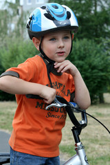 boy riding bike in a helmet
