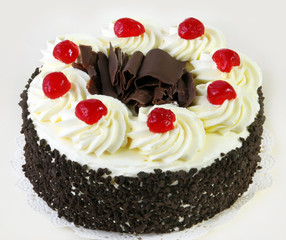 Black forest cake, topped with whipped cream and cherries.