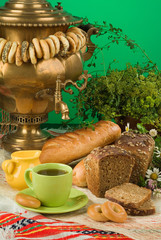 Russian water boiler called "Samovar", greenery and cup of tea