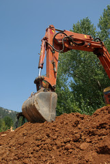 Working  witch excavator on a heap of red ground